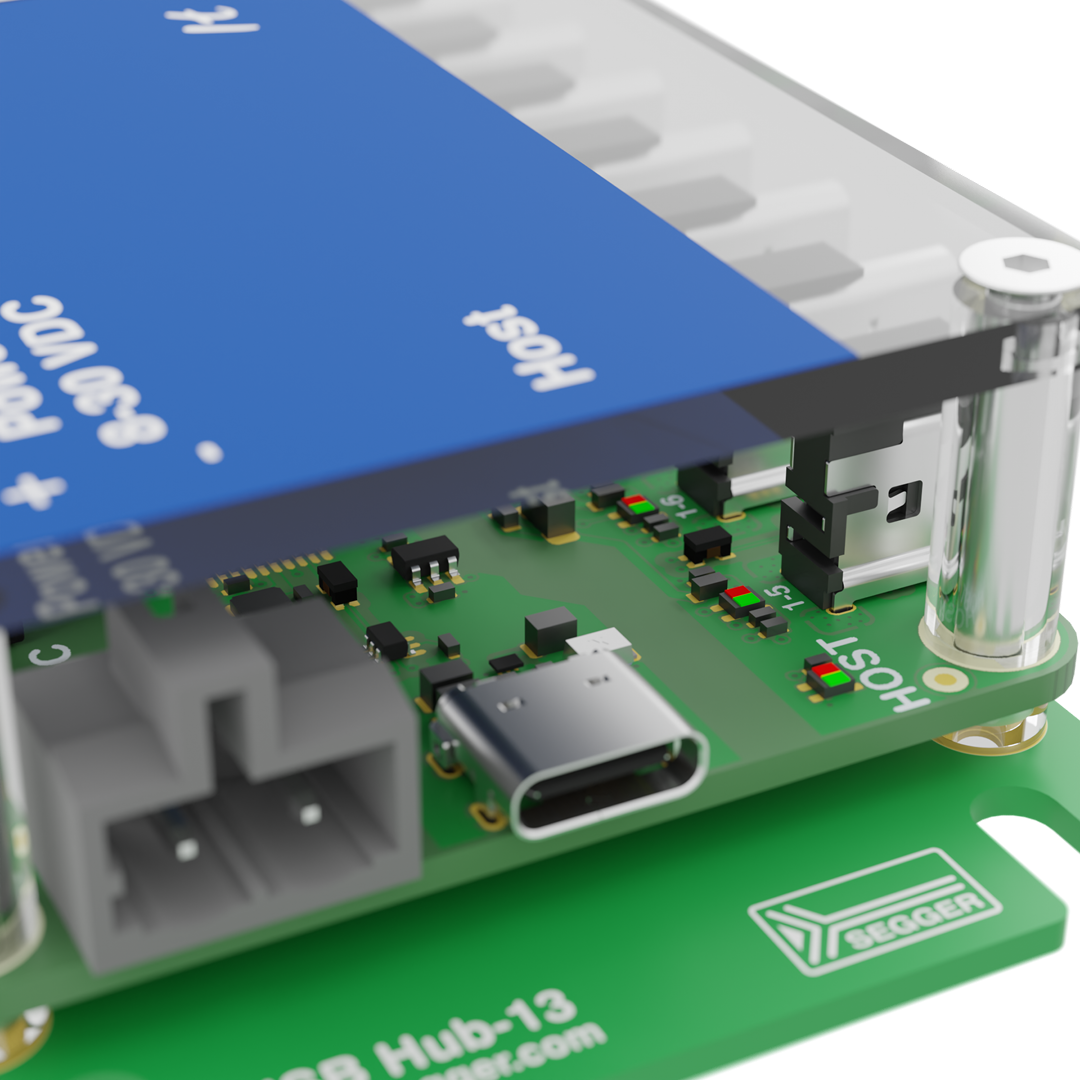 A close-up view of a green circuit board with various electronic components, including connectors and chips. A blue component is positioned above the board, labeled "Host." The overall setup suggests it is part of a USB hub design.
